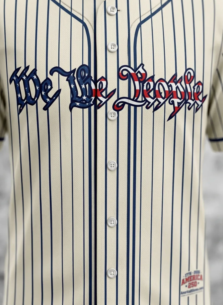 Front view of patriotic baseball jersey with 'We The People' text, vertical stripes, and anniversary logo